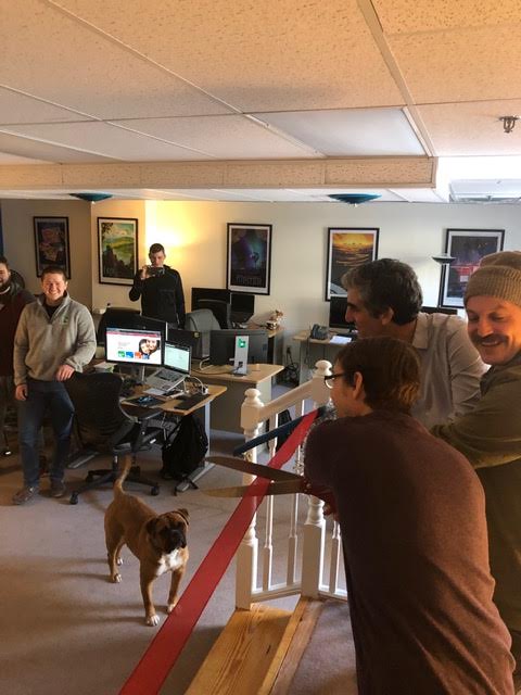 Pete, Jay, and mayor weinberger butting the ribbon to the second floor office