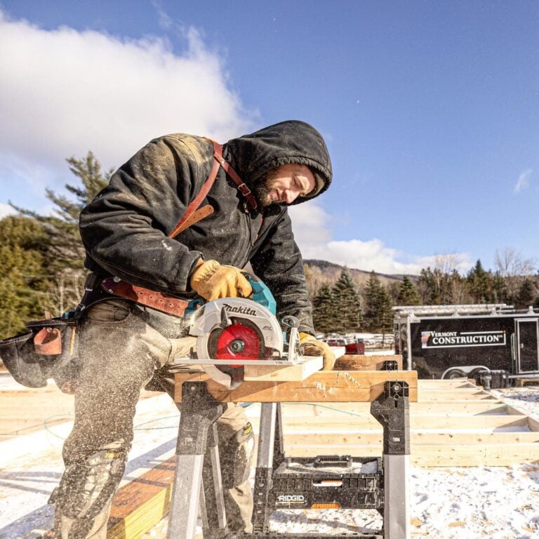 Vermont Construction Company employee working with a saw