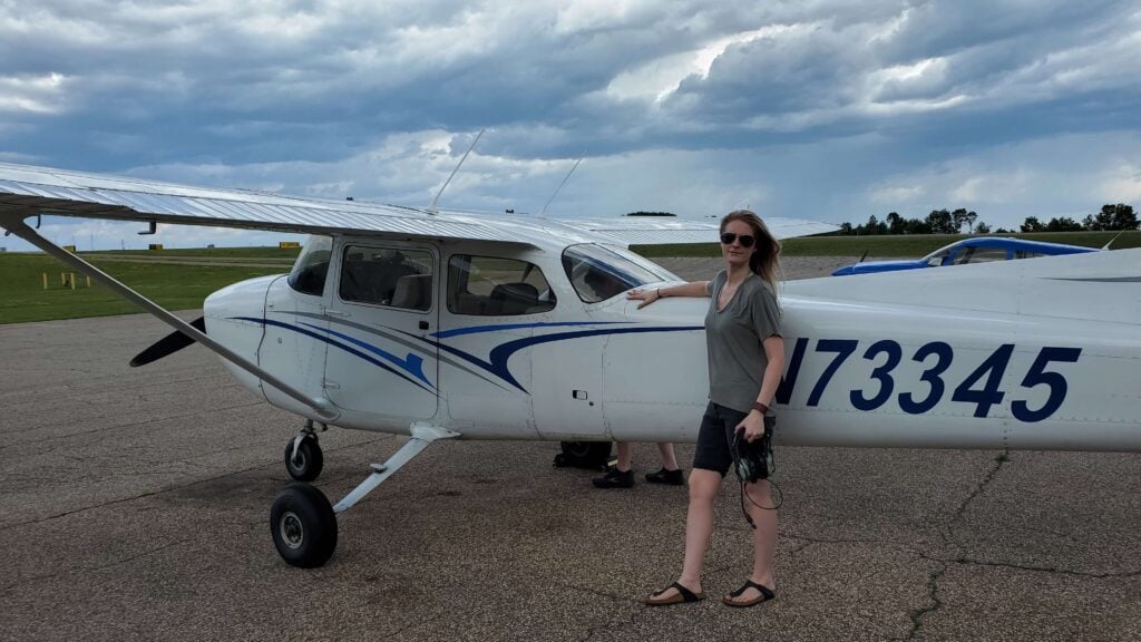 Dorian posing alongside a small plane