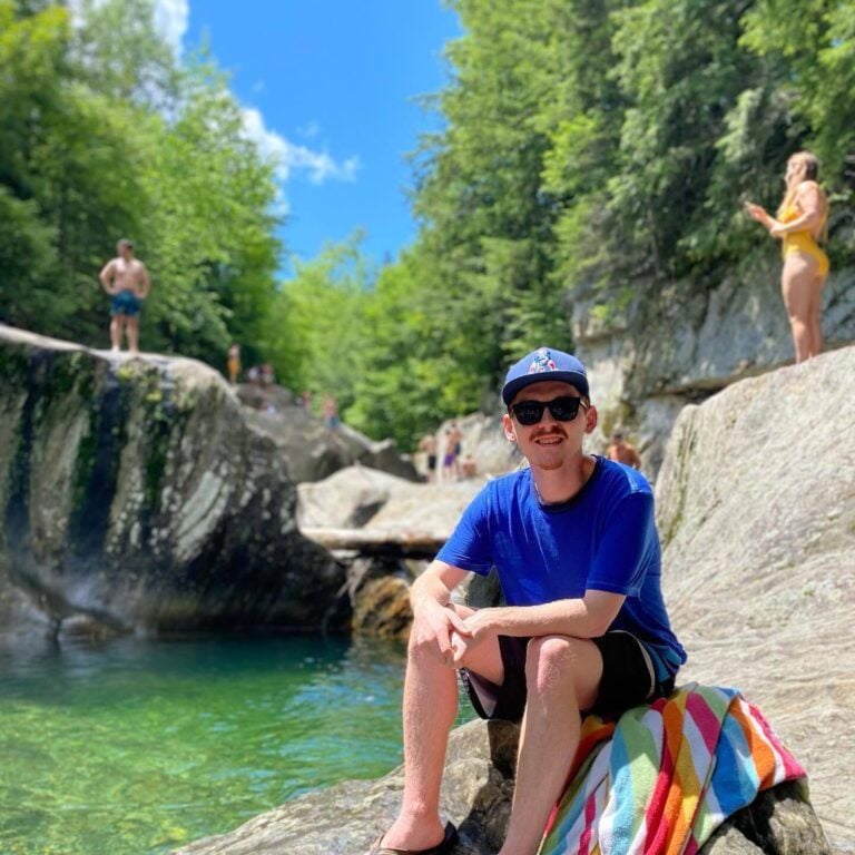 Digital Marketing Manager Scott sitting by a river on a sunny day