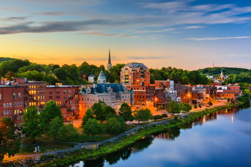 Red brick buildings downtown in Augusta, Maine on the Kennebec River at night