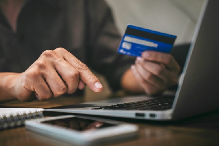 Person shopping on a laptop entering their credit card information