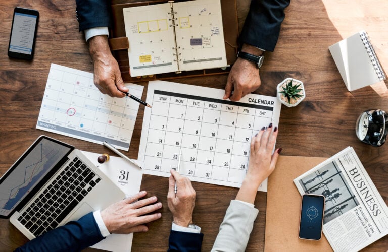 Employees working on a holiday marketing calendar together