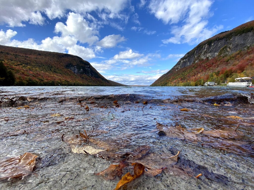 Scenic photo of a lake with a mountainous backdrop