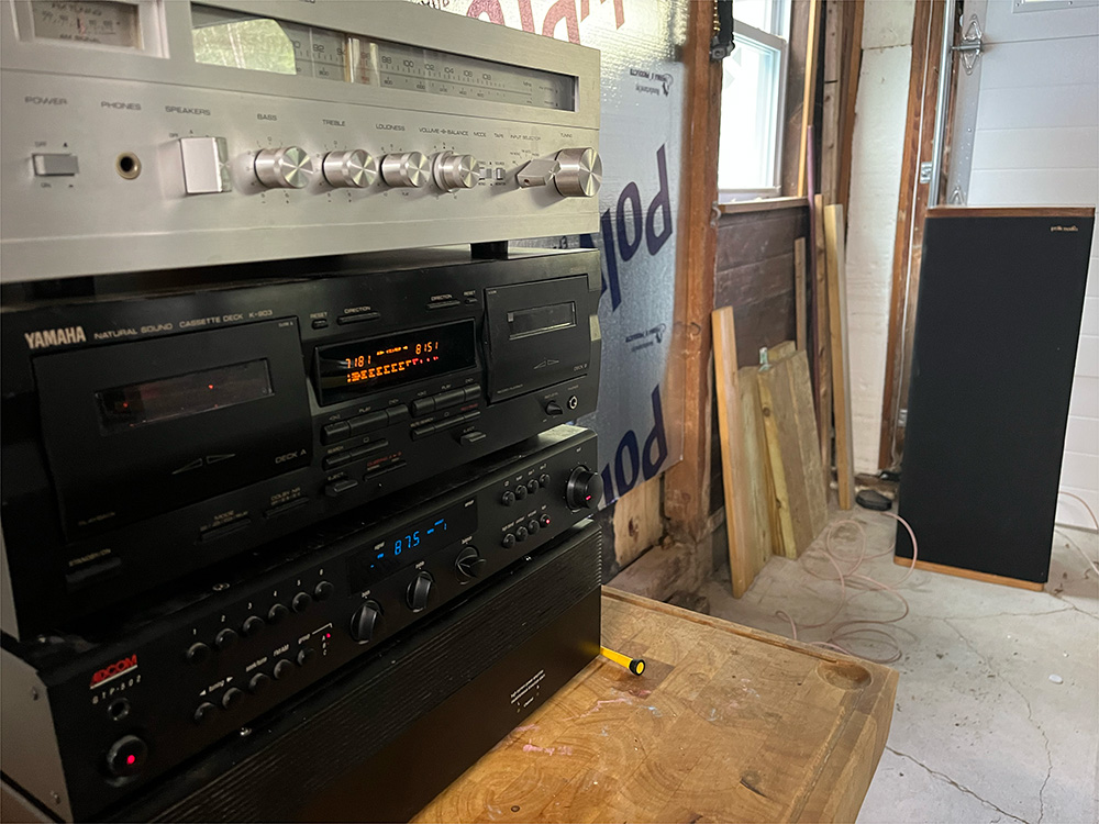 a yamaha stereo system with speaker in background