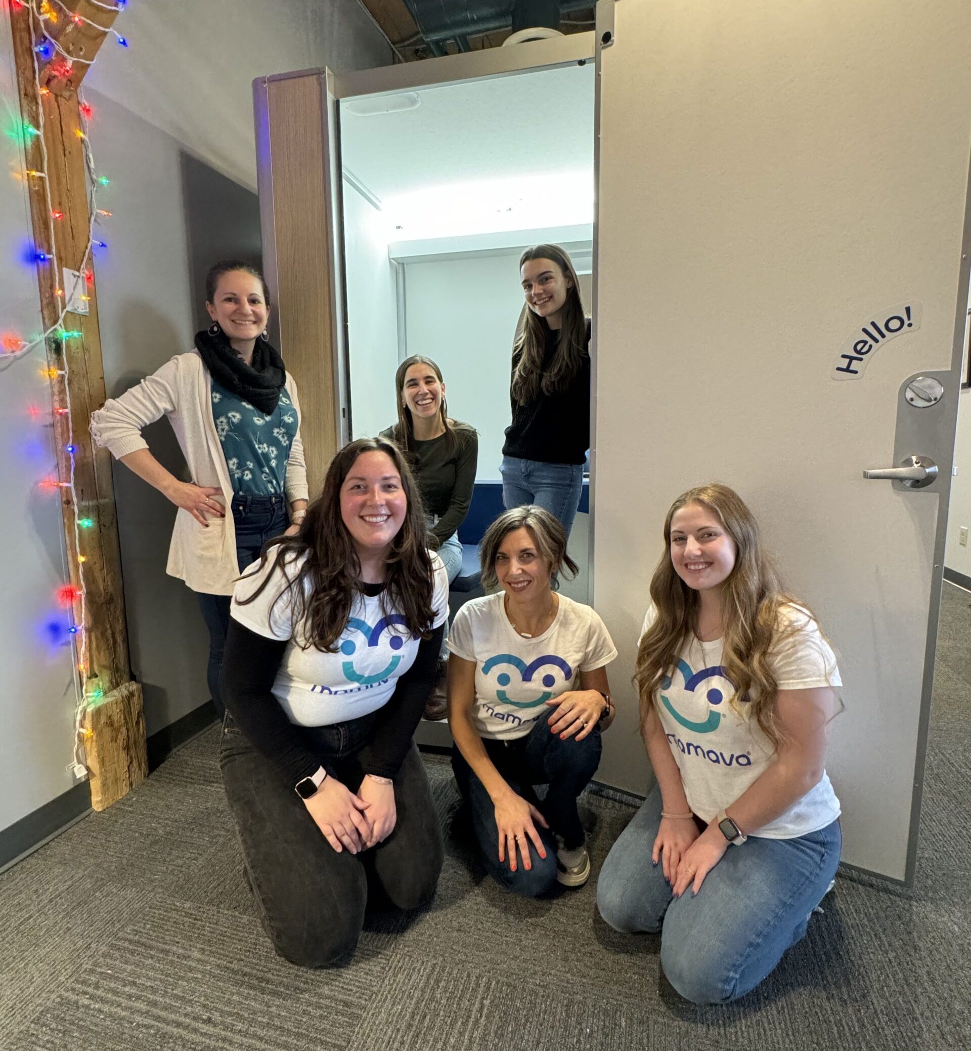 Three of Bytes.co's female employees, Sarah, Abby, and Shea standing in a Mamava lactation pod at the new Bytes.co office on 7 Kilburn St. with Mamava team members