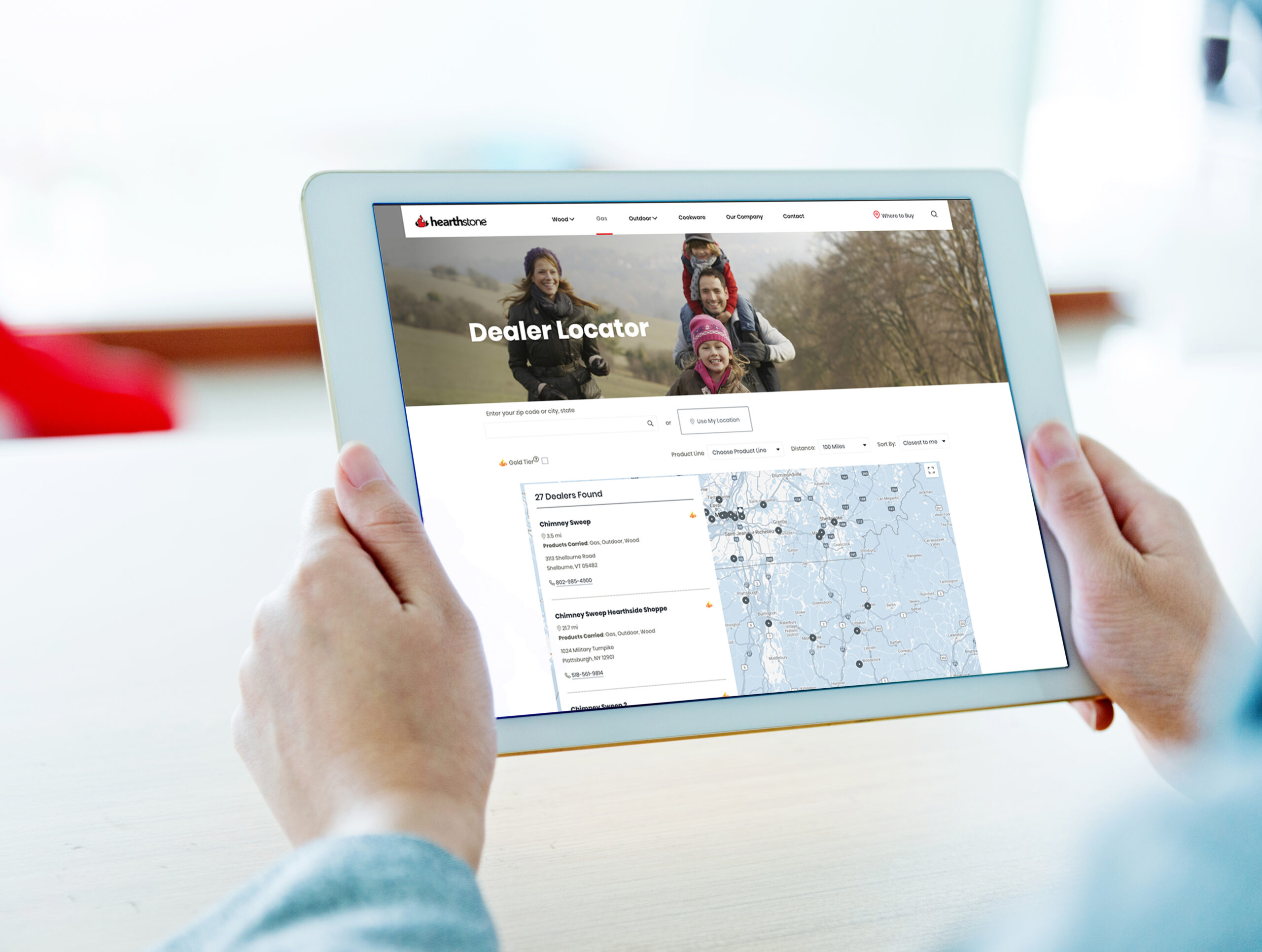 HearthStone Stoves dealer locator page on iPad. iPad is being held by two hands.