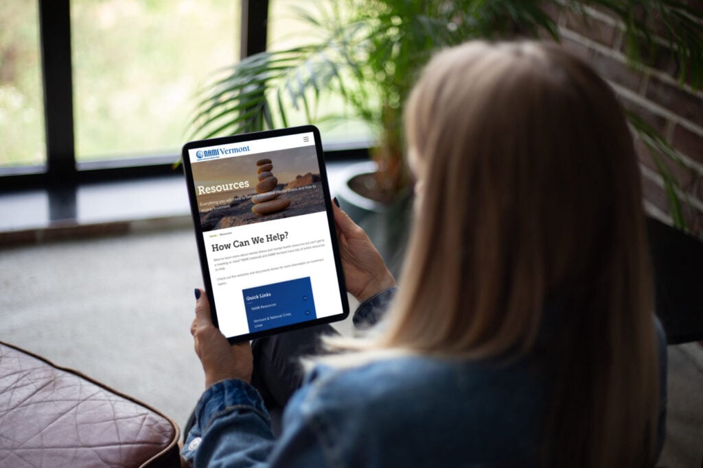 person browsing tablet opened to the resource page on NAMI Vermont
