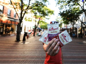 Man Holding UnTapped Waffles on Church Street in Burlington, Vermont