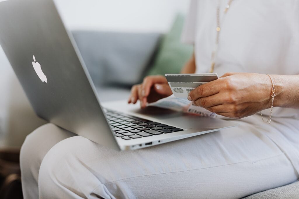 Woman shopping online with laptop and credit card