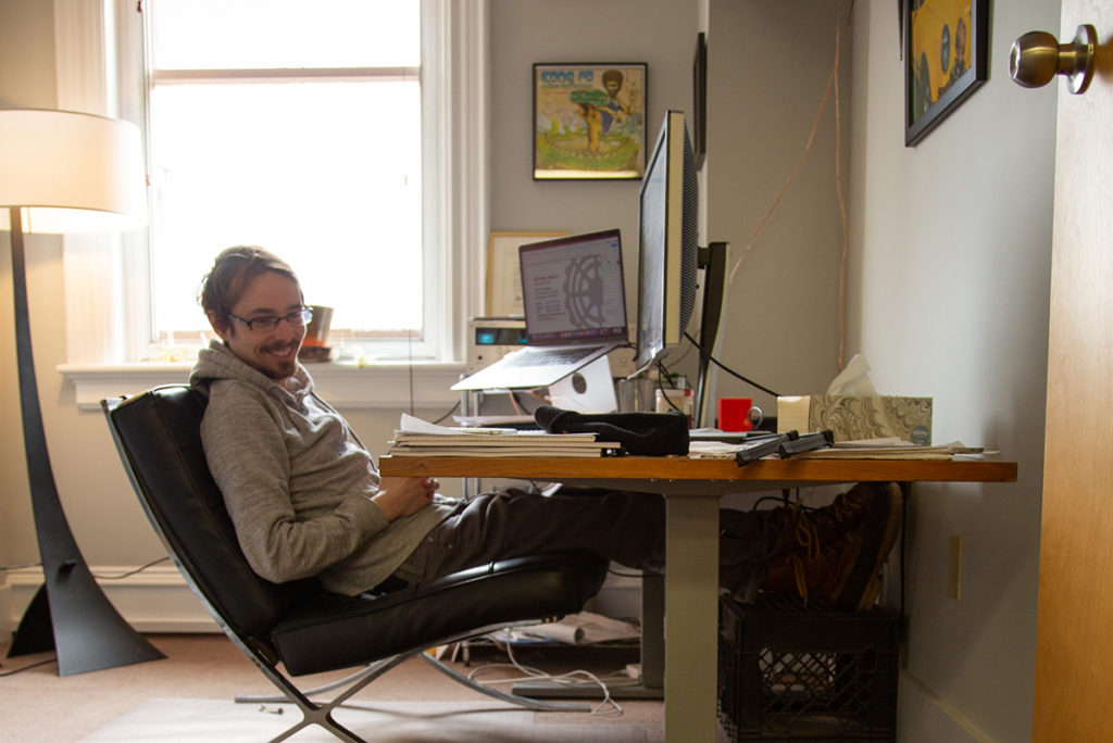 Jay smiling at his desk