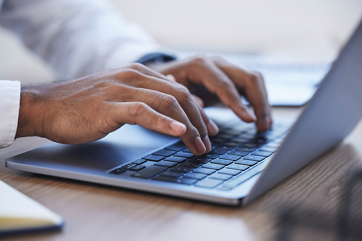 Zoom of businessman's hands working on a computer for writing a proposal